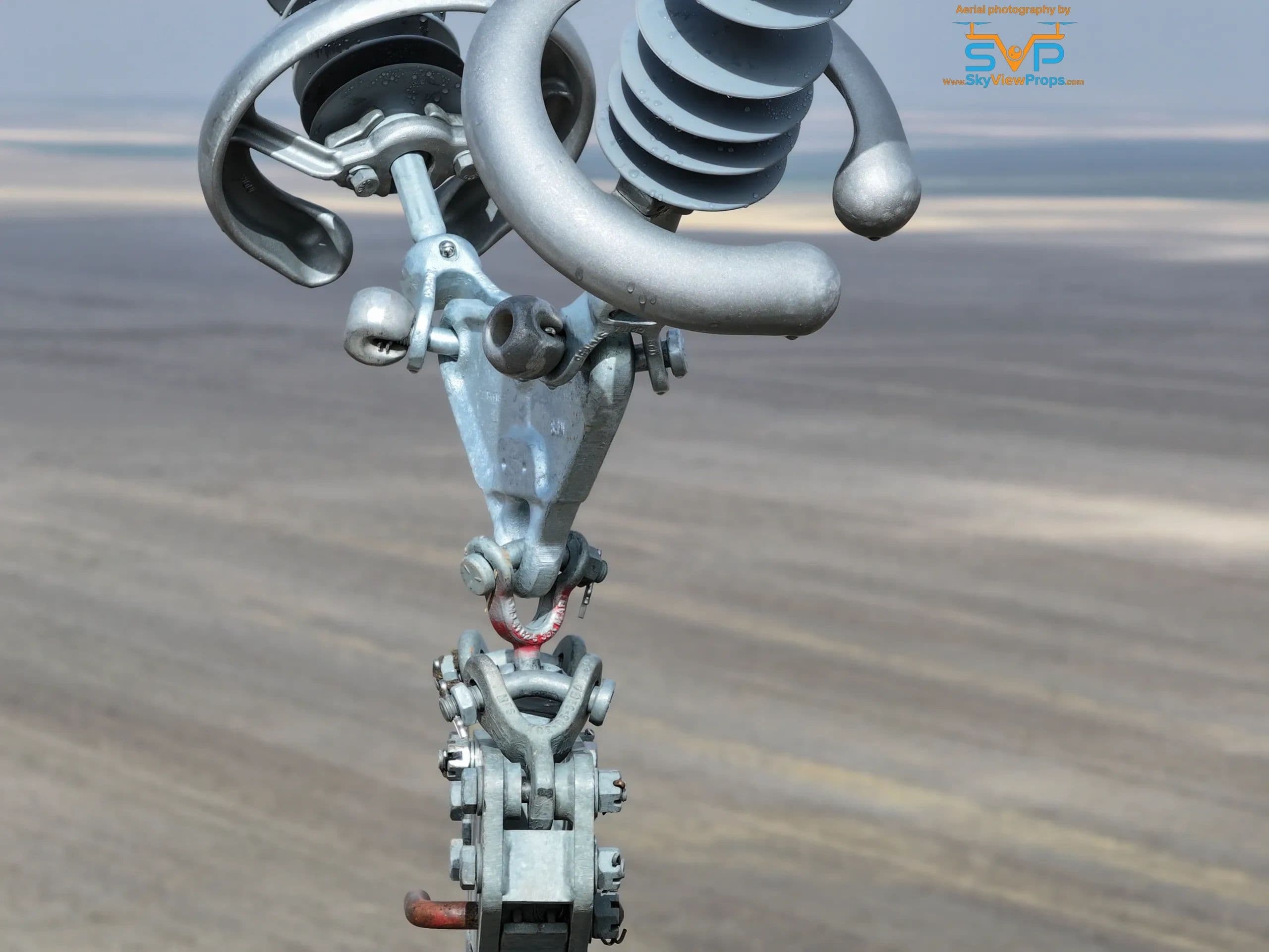Close aerial view of transmission insulator hardware