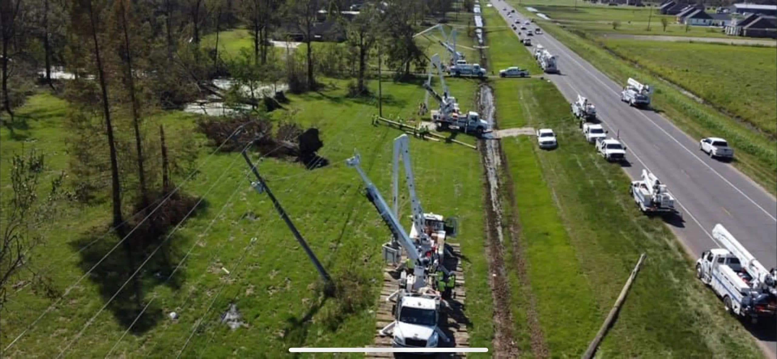 Aerial view of utility crews restoring a powerline corridor